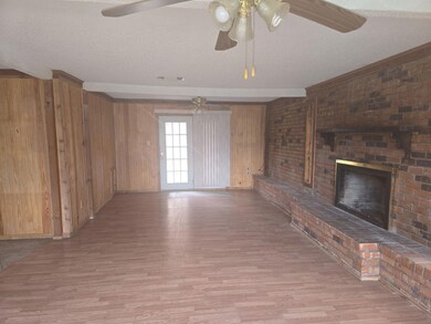 Unfurnished living room with wooden walls, ceiling