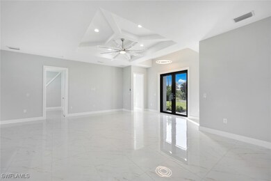 Spare room with french doors, ceiling fan, and a r