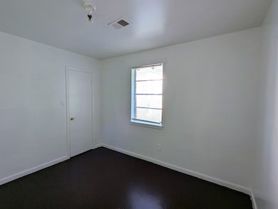 Unfurnished room with baseboards and visible vents
