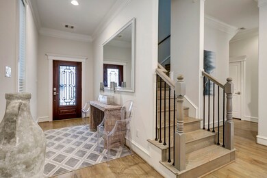 The spacious entryway offers many options for functional pieces, including a bench, sofa table, or shoe rack.