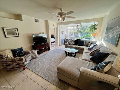 Living room featuring visible vents, ceiling fan,