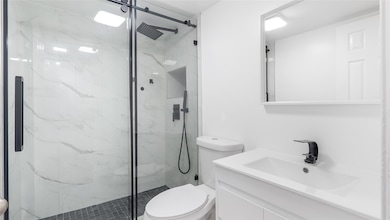 Modern guest bathroom with glass enclosed shower