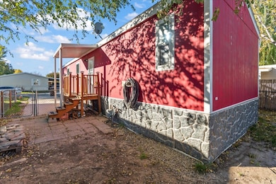 View of property exterior featuring a gate and stone siding