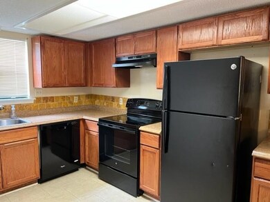 Kitchen with black appliaces.