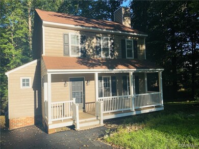 Colonial inspired home featuring a porch