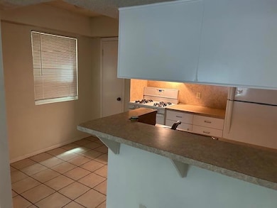 Kitchen featuring white appliances, white cabinet