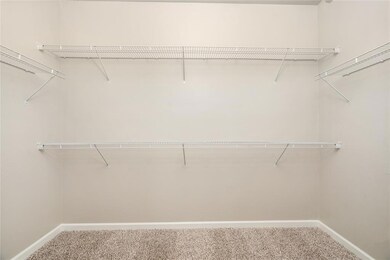 Dream Walk-In Closet! This expansive walk-in closet offers plenty of shelving and storage space, making organization effortless and stylish.