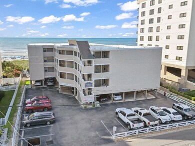 View of property with uncovered parking and a water view