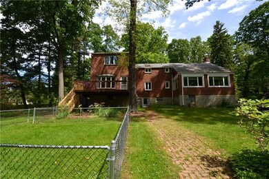 Back of home with a fenced in area