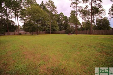 Fully fenced back yard with fire pit