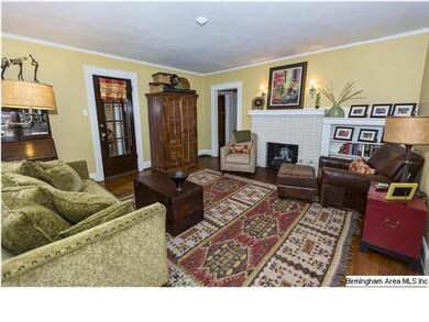 Living room with hardwood floors and cozy fireplac