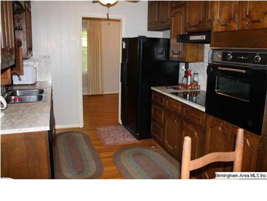 Kitchen has black appliances, and fridge to remain