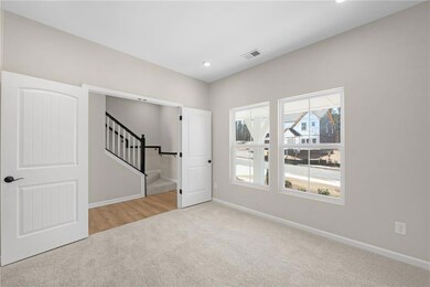 Empty room featuring stairway, carpet, visible ven