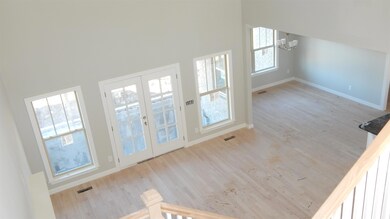 View from upstairs looking into Great room & Breakfast room.  Pics are from a previously built home 