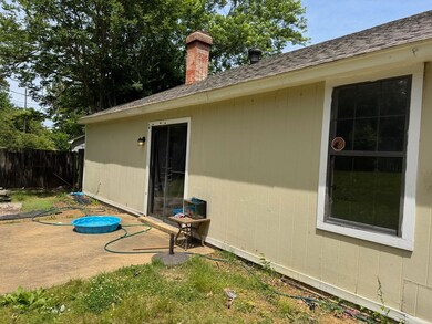 View of home's exterior featuring fence, a chimney
