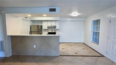 Kitchen featuring kitchen peninsula, white cabinet