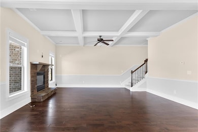 Unfurnished living room with stairs, wood-type flo