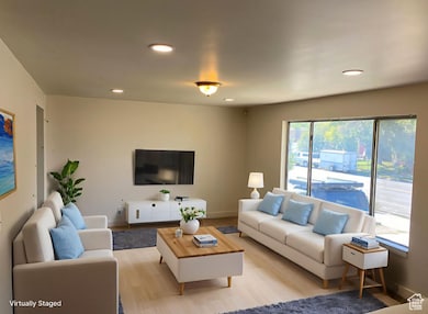 Living area with recessed lighting and baseboards