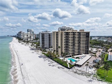 Drone / aerial view of waterfront with a beach and a pool
