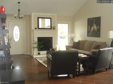 Open to the warm & charming living room with woodburning fireplace, gorgeous hardwood floors, and plenty of light.