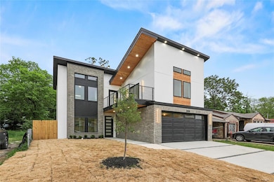 Contemporary house with a balcony, concrete drivew