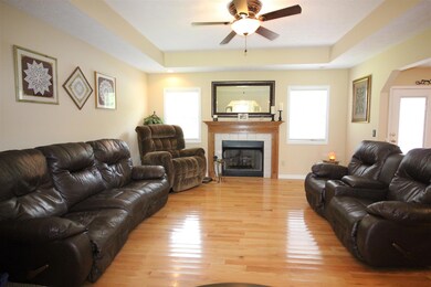 The living room with the open style floor plan and nice fireplace. 16x13