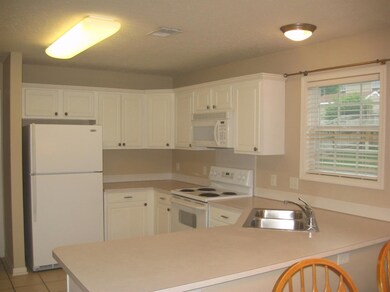 Kitchen has ceramic tile and includes al