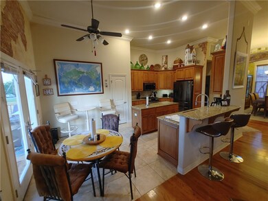 Kitchen has granite island and counter tops with t
