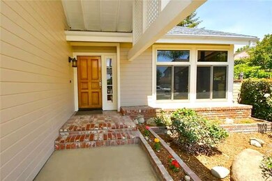 Covered entryway with brick garden beds