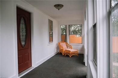 Enclosed front porch has room to relax, read or pl