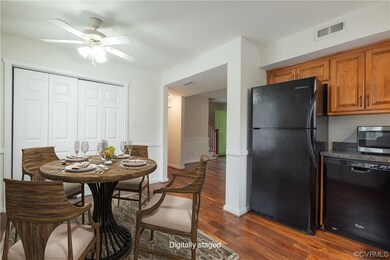 Dining space with dark hardwood / wood-style floor