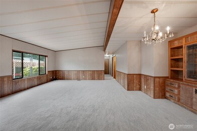 The hallway off the Living Room goes to a hall bathroom, 2 bedrooms, and the Primary Suite.