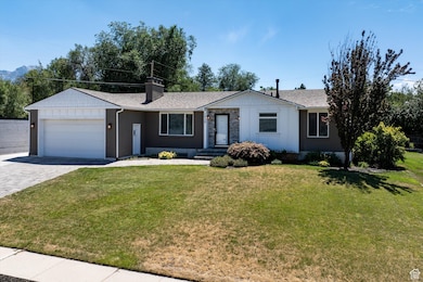 Ranch-style house with an attached garage, decorative driveway, brick siding, and a front lawn