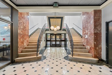 Stairway featuring a chandelier