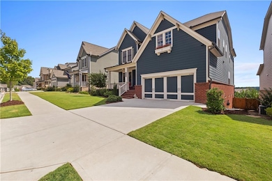 Craftsman inspired home featuring brick siding, driveway, a garage, and a residential view