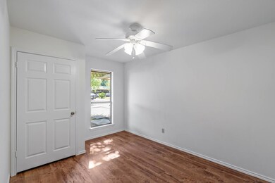 Unfurnished bedroom featuring wood finished floors and a ceiling fan