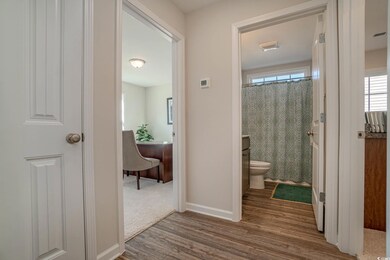 Hall with dark colored carpet