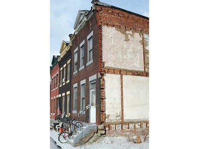 Exterior Front. The row house to the left was torn