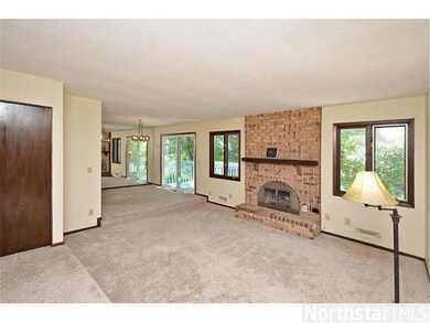Sunken Living Room features brick wood-burning fir