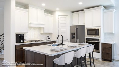 Kitchen with stainless steel appliances, backspla