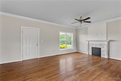 Unfurnished living room featuring crown molding, a