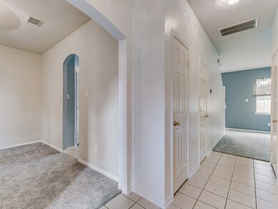 View of front hallway with living room at the back.  There is a half bath off the hallway