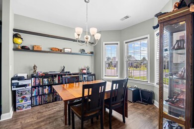 Dining space with a chandelier and wood finished floors
