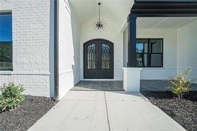 Entrance to property featuring french doors and brick siding