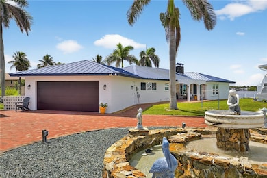 Ranch-style house featuring a standing seam roof,