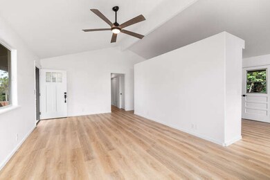 Living Room w/ Vaulted Ceilings. Kitchen & Dining Area on the Right of the Photo