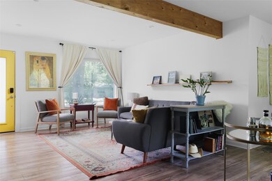 Living room with wood finished floors and baseboa