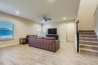 Living room featuring recessed lighting, light wood-style floors, ceiling fan, and stairway
