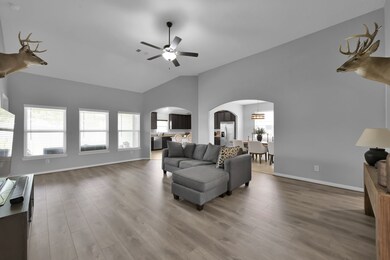 This spacious living area features high ceilings,