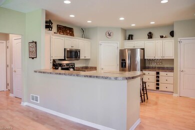 The kitchen has a breakfast bar and ample cabinet 